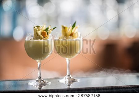Two Cocktails Pina Colada At Barcounter In Night Club Or Restaurant.