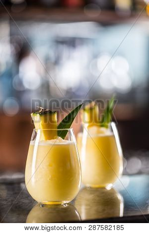 Two Cocktails Pina Colada At Barcounter In Night Club Or Restaurant.