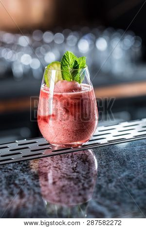Cocktail Drink Frozen Strawberry Daiquiri At Barcounter In Night Club Or Restaurant.