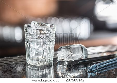 Ice Cubes In Glass At Barcounter In Night Club Or Restaurant.