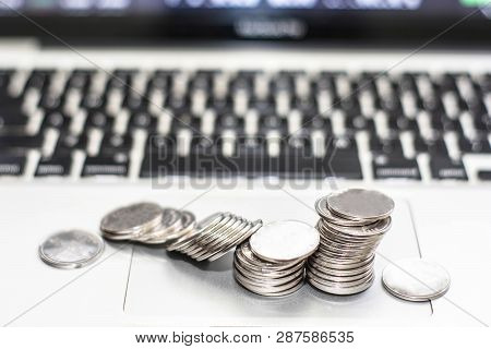 Silver Coin With Monitor Shows Trading Traffic, Bitcoin Minning, Coin Colapse Infront Of Monitor Lap