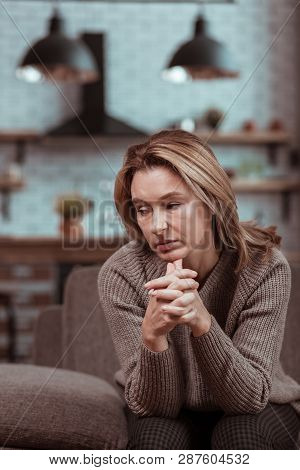 Blonde-haired Housewife Sitting And Waiting For Her Husband Coming Home