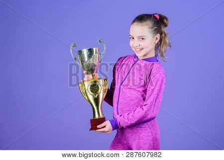 Adorable Cup Winner. Small Girl Holding Silver Cup. Little Child With Cup Shaped Sports Trophy. Cute