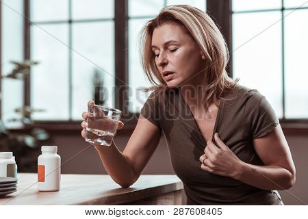 Blonde Woman Suffering From Depression Drinking Water