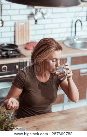 Sick Woman Feeling Bad Drinking Water After Taking Pill