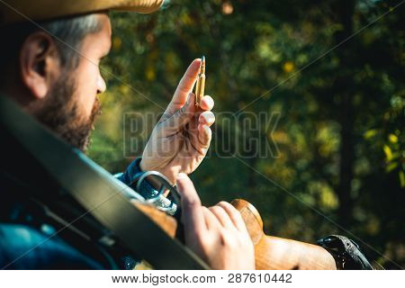 Hunter With Shotgun Gun On Hunt. Closed And Open Hunting Season. Big Game. Gun Rifle And Cartridge C