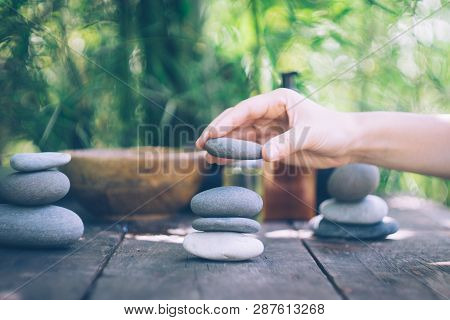 Spa Background With Woman's Hands And Clear Water On An Old Wooden Table. Japanese Style. Simplicity