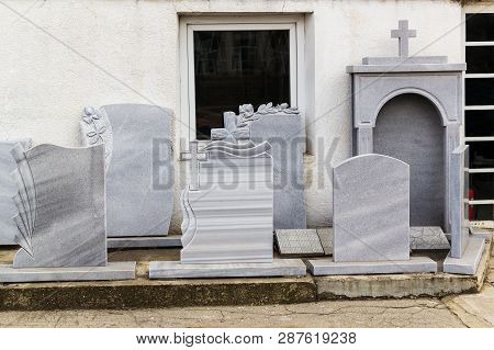 Small Private Firm Produces Tombstones And Exhibites Samples Of Its Products On The Street.