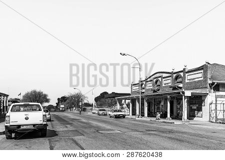 Koppies, South Africa, July 30, 2018: A Street Scene, With Businesses And Vehicles, In Koppies, A To