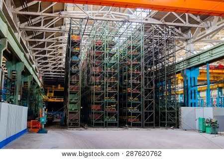 The Interior Of A Large Warehouse Of Heavy Iron Products And Metal Goods With Pallet Storage Shelves