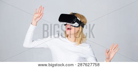 Woman Wearing Virtual Reality Goggles. Amazed Young Woman Touching The Air During The Vr Experience.