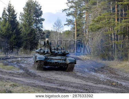 Russian Battle Tanks On The Exercises In The Forest Area