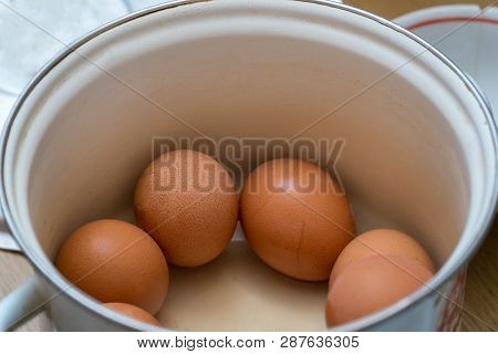 Raw Chicken Eggs In A Pan In The Kitchen. Selective Focus