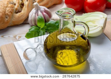 Virgin Natural Olive Oil Is Glass Bottle, Served With Traditional Mediterranean Food