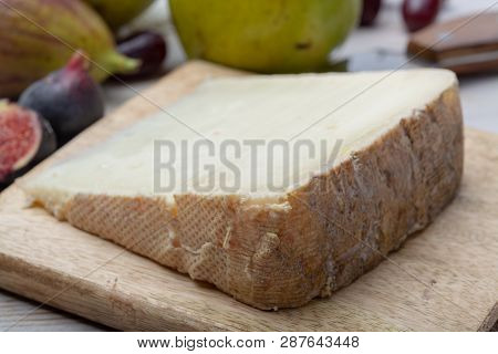 Piece Of French Cheese Tomme De Brebis Made From Sheep Milk Served As Dessert With Fresh Figs And Pe