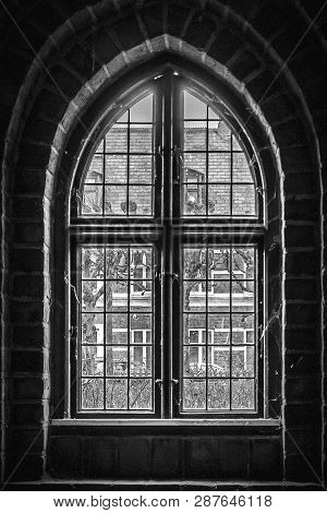 Through The An Arched Window At The Church Of Saint Mary In The Old Town Of Helsingor In Denmark.