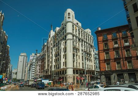 Old Buildings With Shops And People On A Busy Street Of Madrid