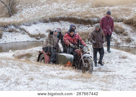 A Team On A Soviet Retro Motorcycle With A Sidecar In The Mud And Snow Riding Cross-country