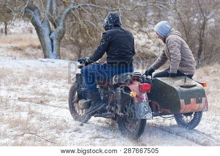 A Team On A Soviet Retro Motorcycle With A Sidecar In The Mud And Snow Riding Cross-country