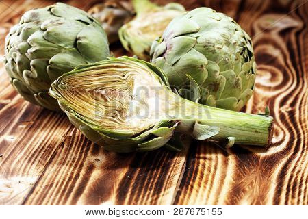 Artichokes On Rustic Background. Fresh Organic Artichoke Flower Set