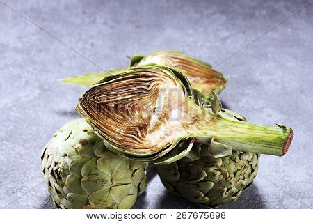 Artichokes On Rustic Background. Fresh Organic Artichoke Flower Set