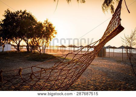 Beach And Sea View With Empty Hammock Sunshades At Sunset Chillout