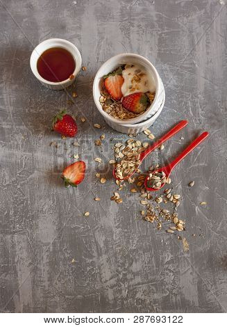 Granola With Honey , Jogurt, Strawberry And Spoons Oatmeal