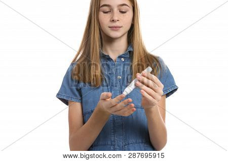 Teen Girl Using Lancet Pen On White Background. Diabetes Control