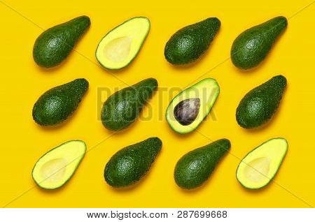 Ripe Sliced Avocado Pattern On Yellow Background Top View. Creative Food Composition Flat Lay. Pop A