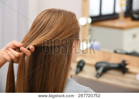 Professional Coiffeuse Braiding Client's Hair In Salon