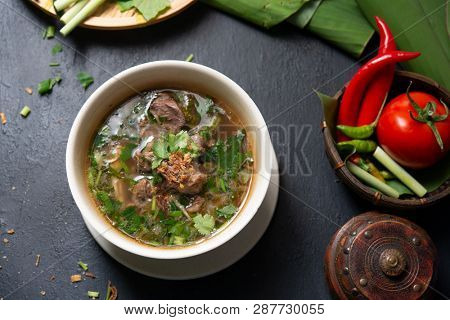 Asian bone soup or sup tulang, popular traditional malay dish. Top view flat lay.
