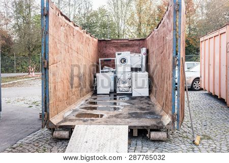 Old electrical appliances like tv sets and washing machines in container of recycling center 