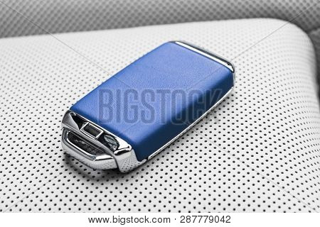 Closeup Inside Vehicle Of Wireless Blue Leather Key Ignition On White Leather Seat. Wireless Start E