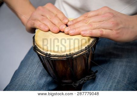 A Man Plays The Ethnic Drum. Close-up.