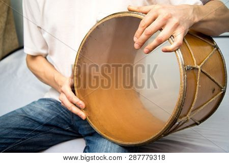 A Man Plays The Ethnic Drum. Close-up.