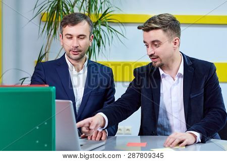 Two Mature Caucasian Male Working In The Office