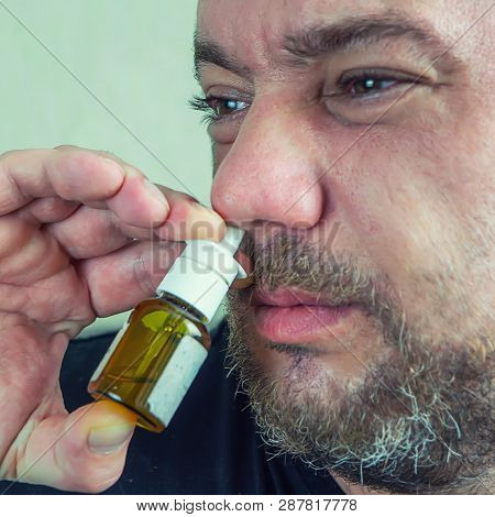 Man With Runny Nose Treats Nose With Nasal Spra
