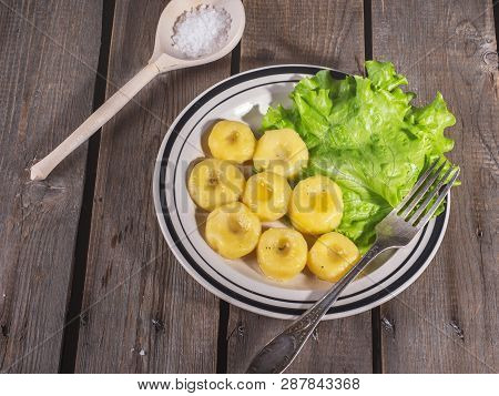 Ceramic Plate With Ready-made Potato Gnocchi With Leaves Of Fresh Leaf Lettuce, On The Plate Lies A 