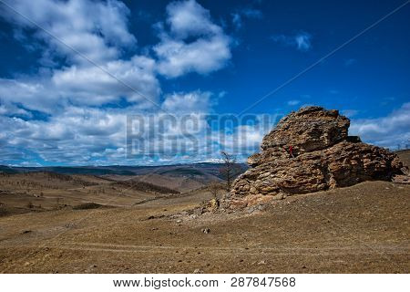 Wide Steppe With Yellow Grass Under A Blue Sky With White Clouds And Climbing Girl Silhouette, Tazhe