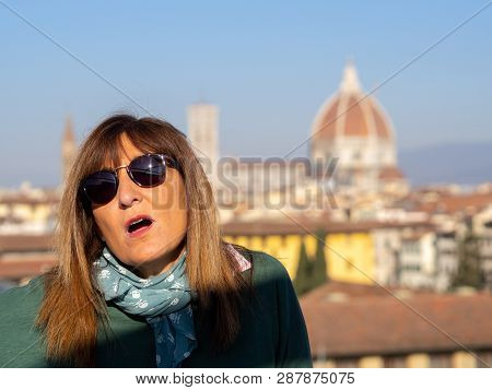 Mature And Beautiful Woman Poses On A Terrace And In Front Of The Florentine Cathedral, Santa Maria 