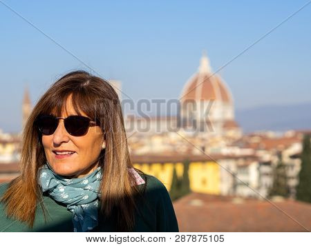 Mature And Beautiful Woman Poses On A Terrace And In Front Of The Florentine Cathedral, Santa Maria 