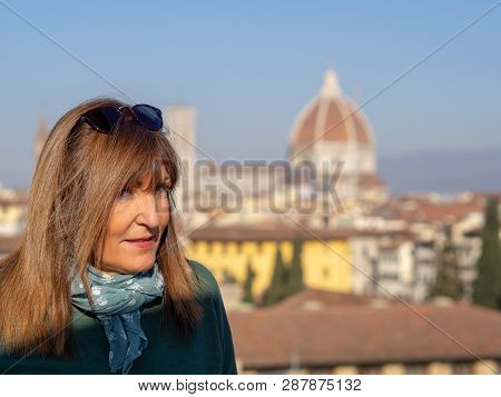 Mature And Beautiful Woman Poses On A Terrace And In Front Of The Florentine Cathedral, Santa Maria 