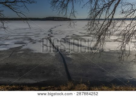 Ice On The Biggest Pond In Czech Republic Rozmberk In Sunny Winter Day With Path On Cold Dark Water