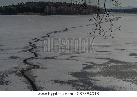 Ice On The Biggest Pond In Czech Republic Rozmberk In Sunny Winter Day With Path On Cold Dark Water