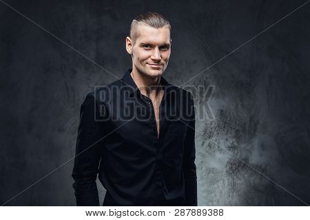 Fashion Portrait Of Handsome With Perfect Haircut And Unbotton Black Shirt Looking At A Camera. Stud
