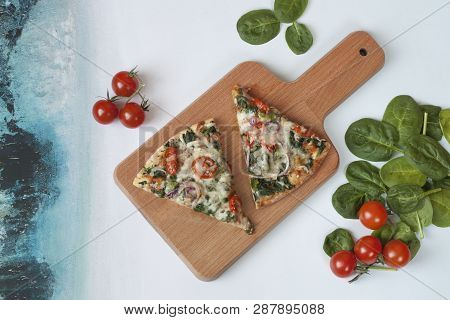 Sliced Spinach Pizza With Tomatoes And Parmesan