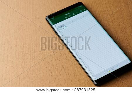 New York, Usa - March 6, 2019: Microsoft Office Excel Menu On Smartphone Screen Laying On Wooden Des