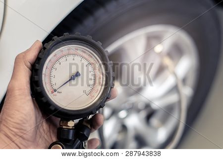 Asian Man Car Inspection Measure Quantity Inflated Rubber Tires Car.close Up Hand Holding Machine In