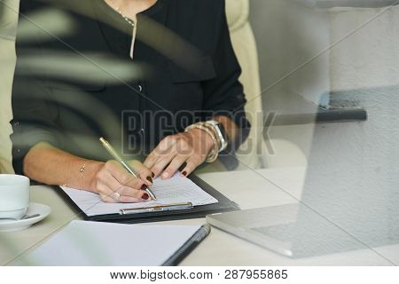 Manicured Hands Of Businesswoman Filling Information In Construction Contrat
