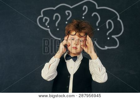 Brooding Boy Elementary School Student At The Blackboard